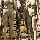 Part of an old photo of people covered in mud